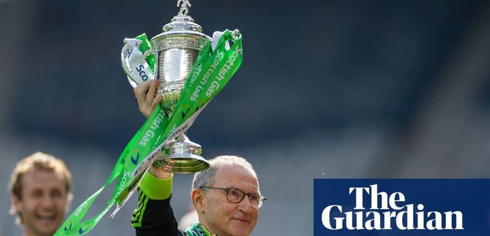 Manager lifting trophy with green ribbons in celebration