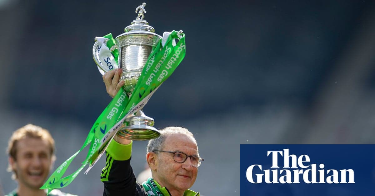 Manager lifting trophy with green ribbons in celebration