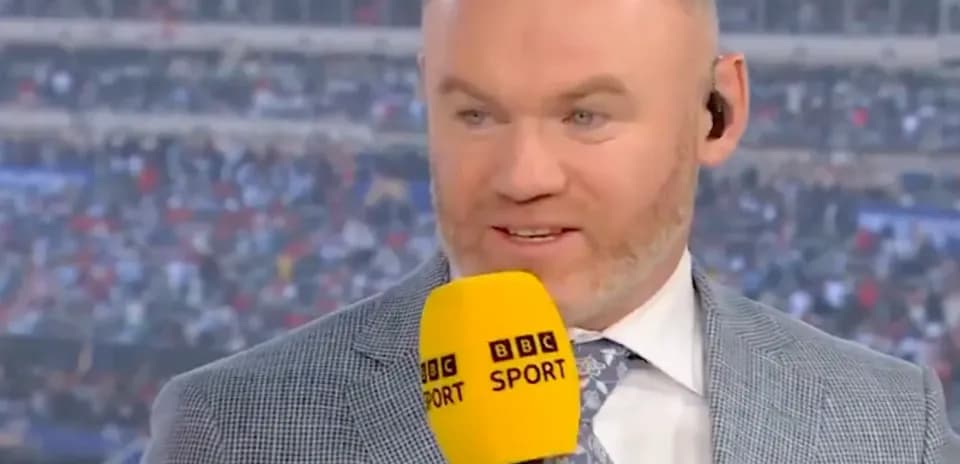 Sports commentator speaking into microphone during broadcast