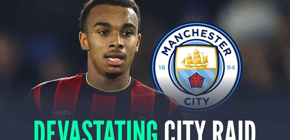 Player wearing black and red jersey with Manchester City logo