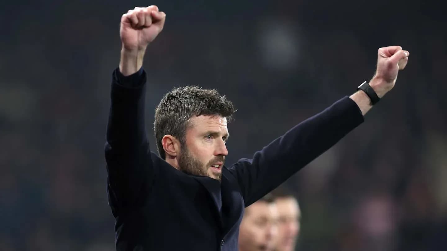 Manager celebrating with raised arms during match