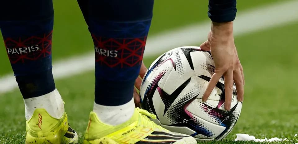 Player placing ball on the field before kick