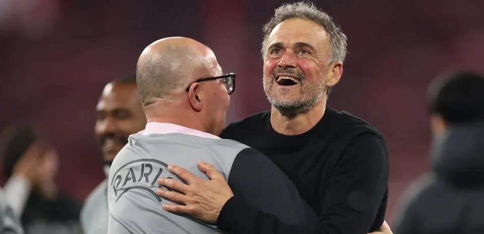 Coaches celebrating with an embrace after match