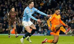 John Stones tackling Real Madrid player