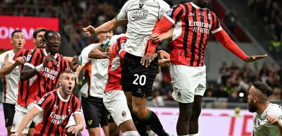 Players contesting for the ball during AC Milan match
