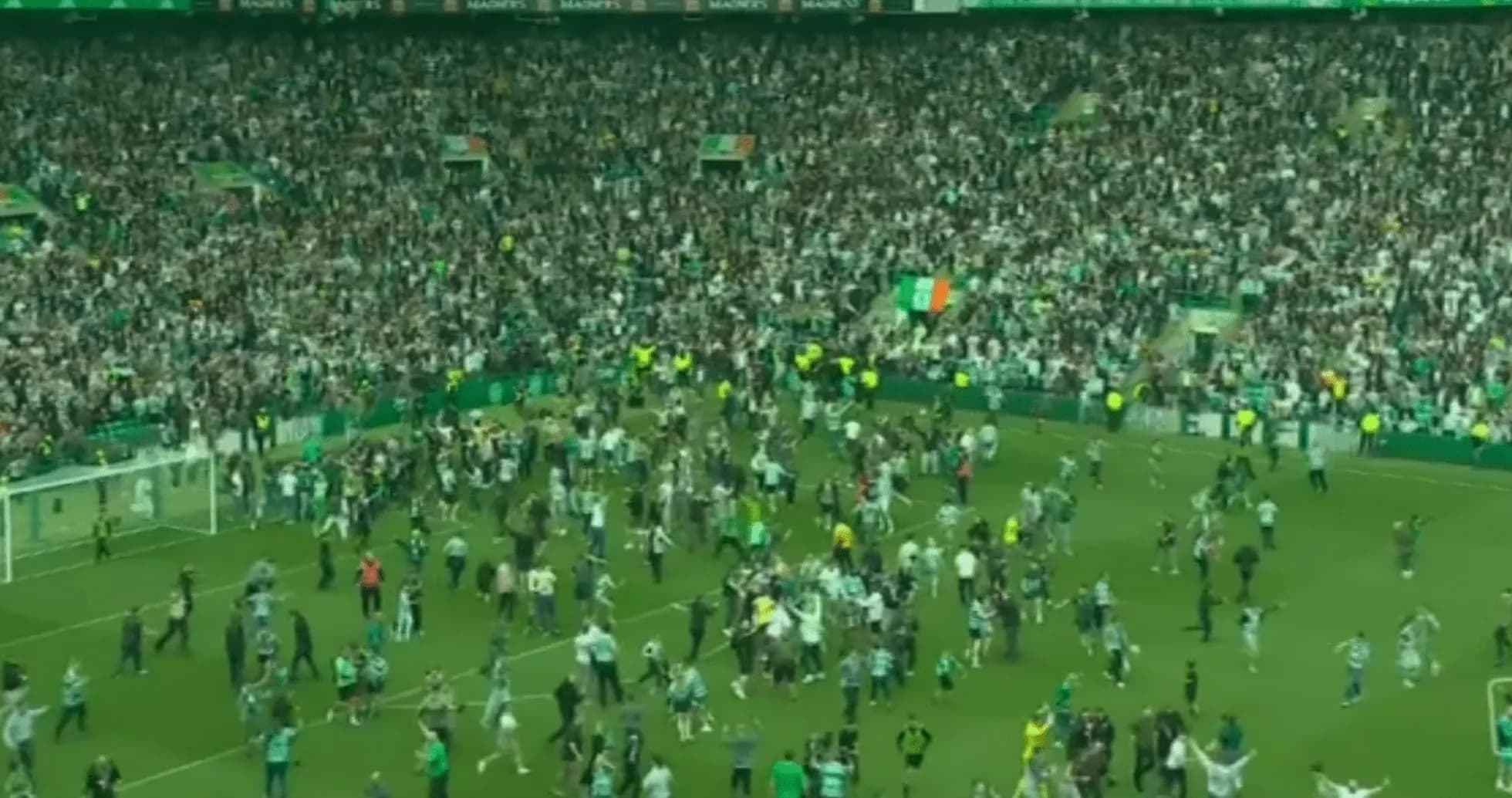 Fans celebrating on the pitch after match