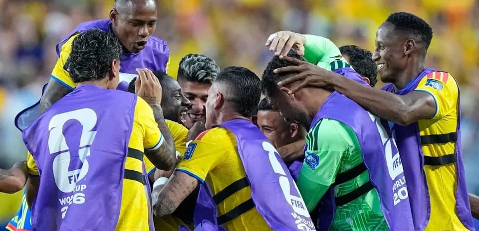 Players celebrating a goal with team jerseys on