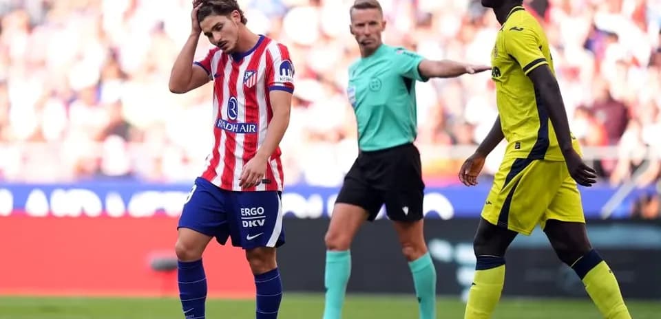Player looking frustrated during match, referee nearby