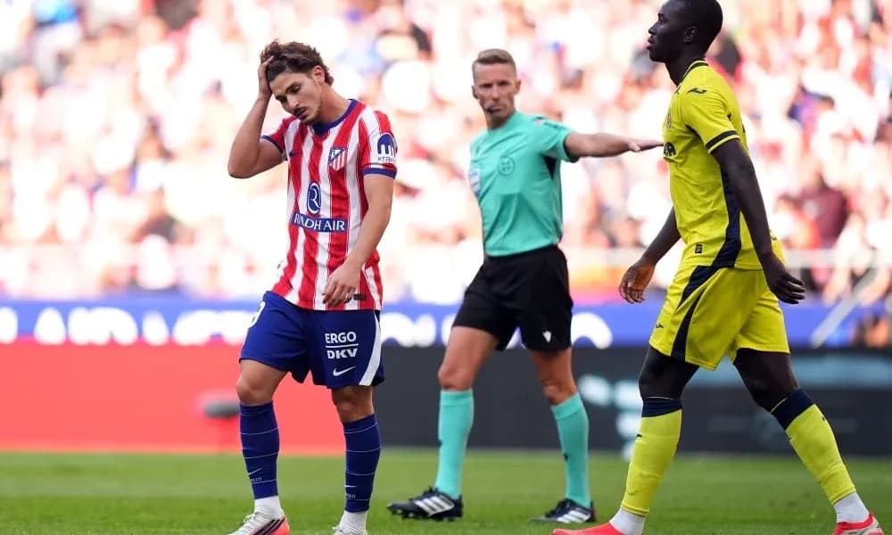 Player looking frustrated during match, referee nearby