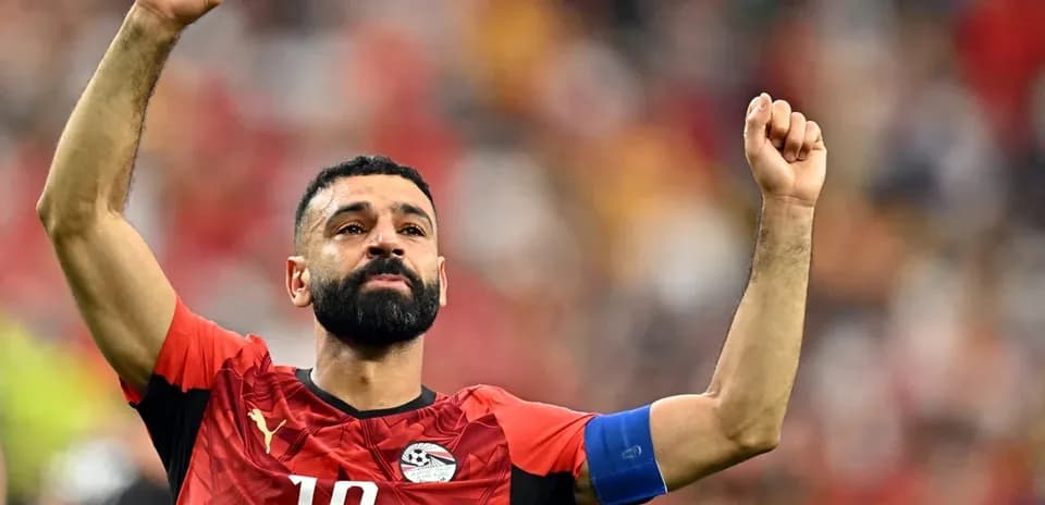 Egyptian player celebrating with raised arms on field