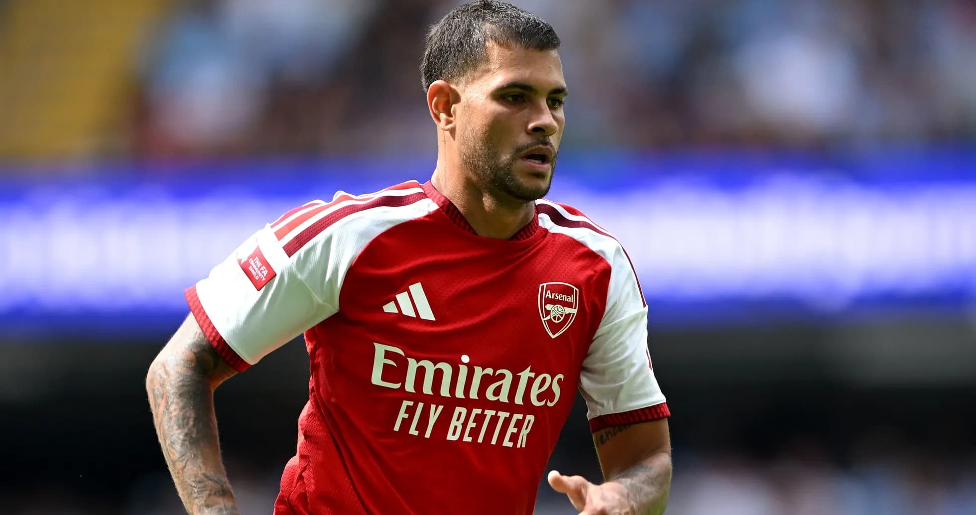 Player in Arsenal jersey running on the field