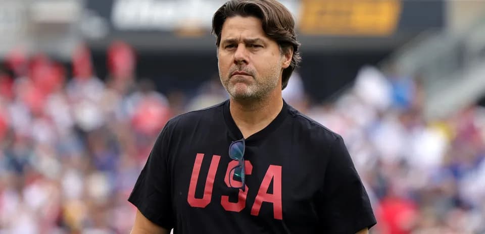 Coach walking on the field during match