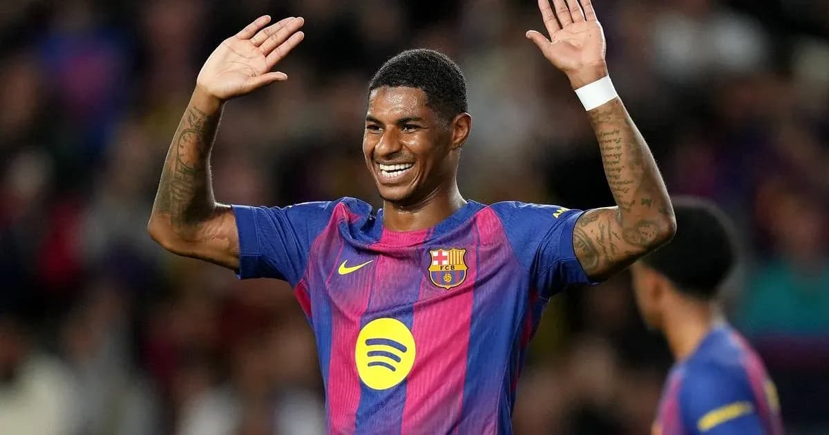 Player celebrating with raised hands on pitch