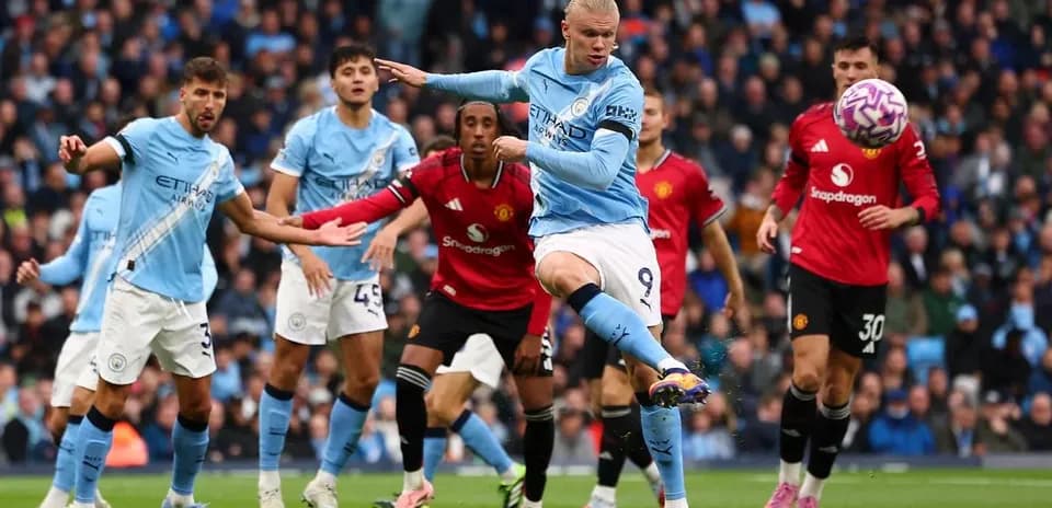 Erling Haaland kicking the ball in Manchester derby