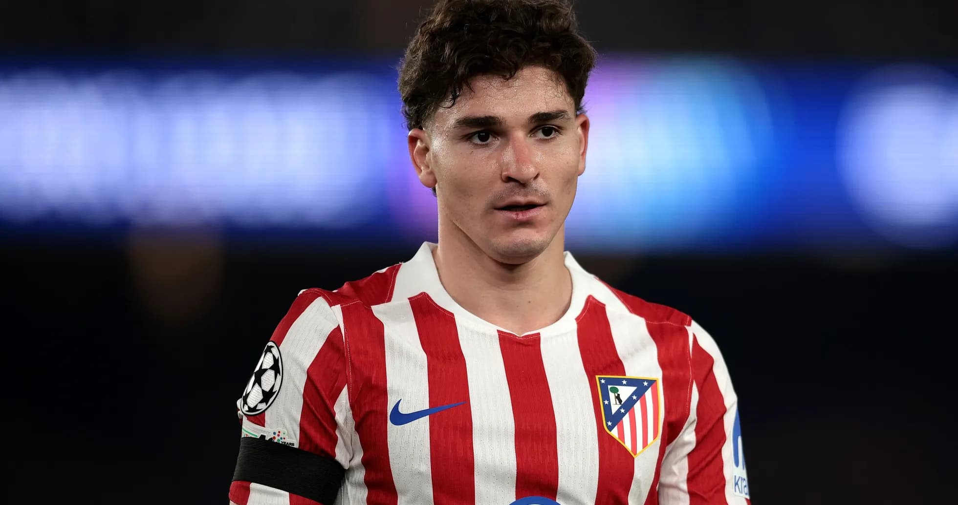 Atletico Madrid player wearing red and white striped jersey