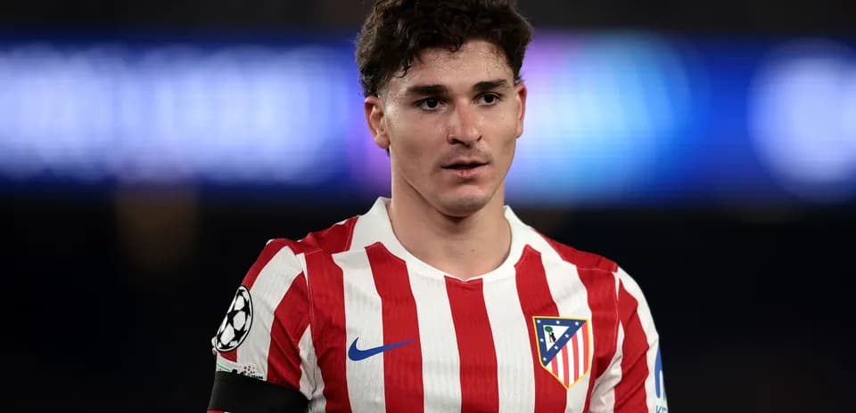 Atletico Madrid player wearing red and white striped jersey