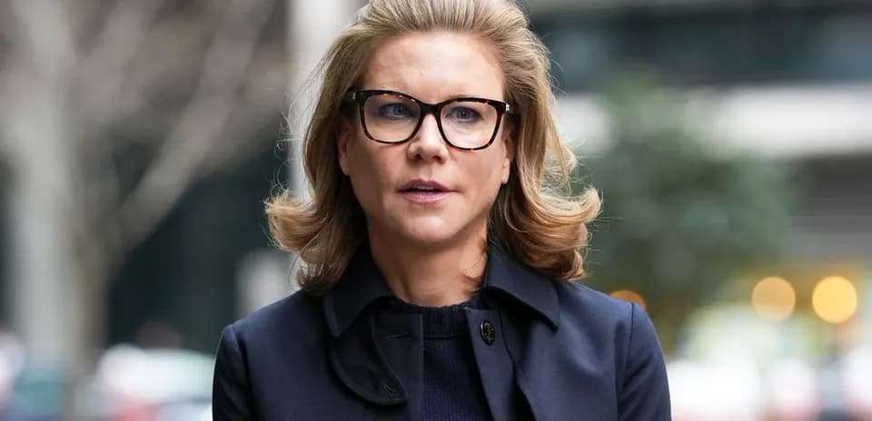 Woman with glasses walking outdoors in urban setting