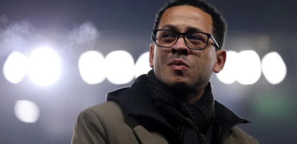 Person in glasses standing under stadium lights