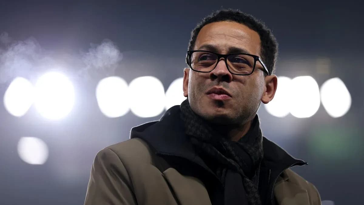 Person in glasses standing under stadium lights