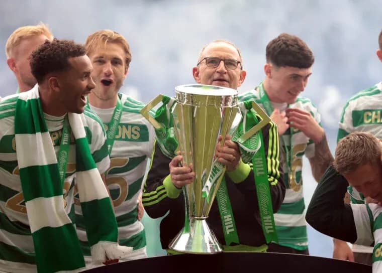 Team celebrating with trophy during victory ceremony