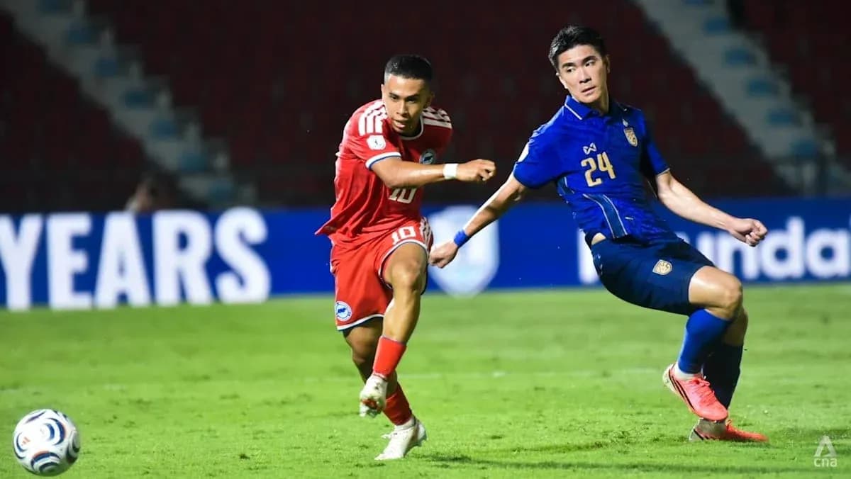 Two football players competing for the ball on field