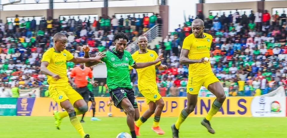 GOR Mahia player dribbling past defenders during match