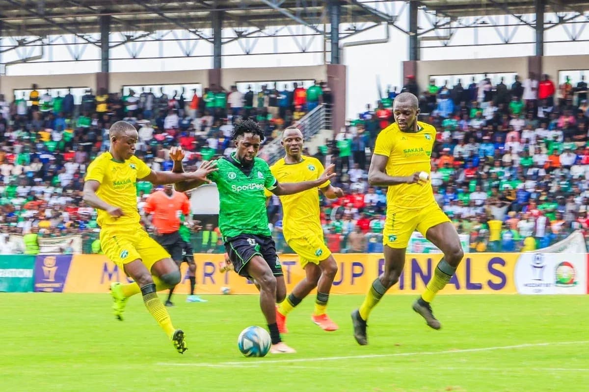 GOR Mahia player dribbling past defenders during match