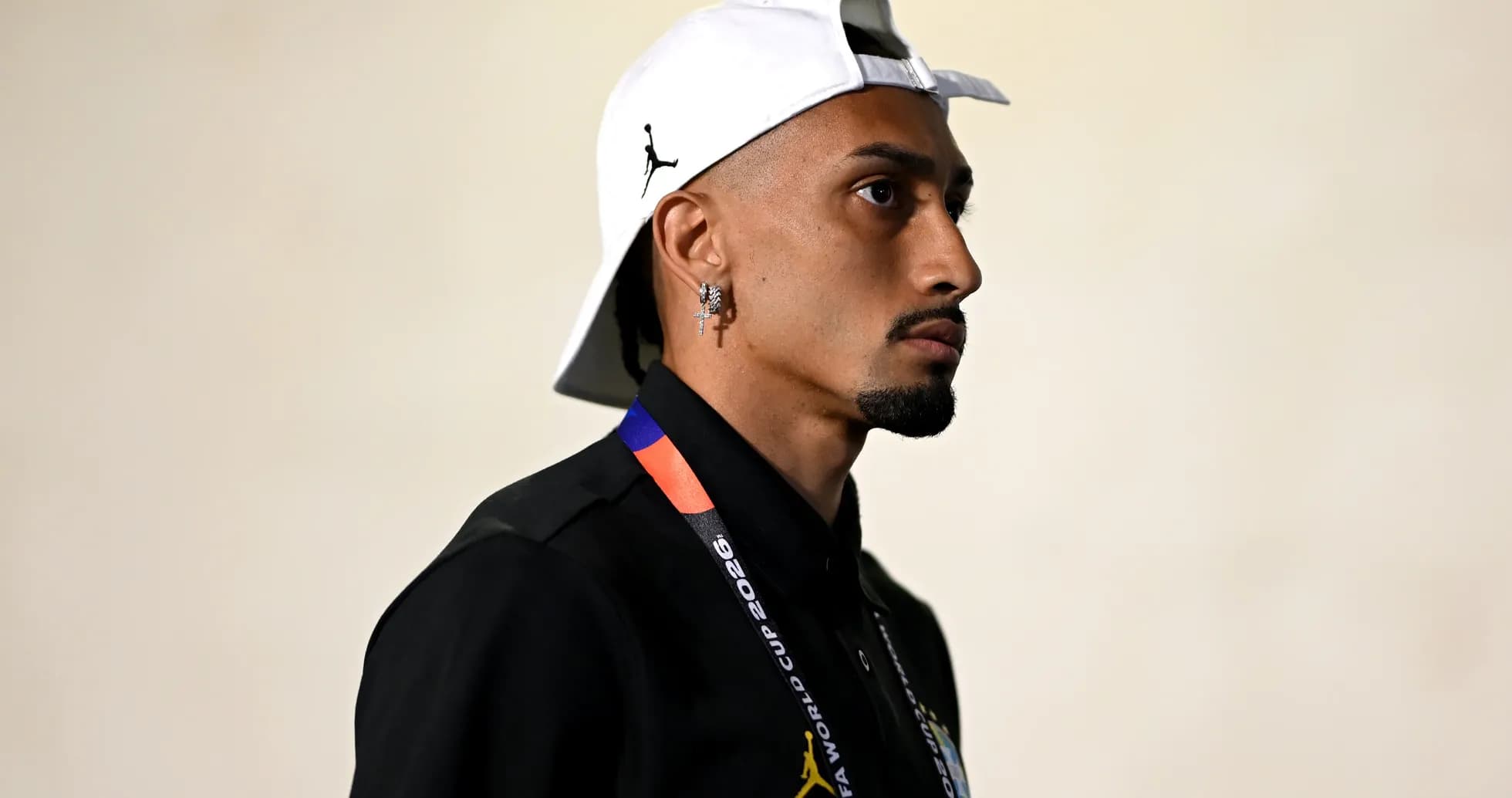 Man wearing a cap and lanyard in profile