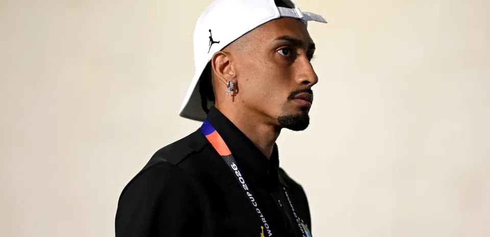 Man wearing a cap and lanyard in profile