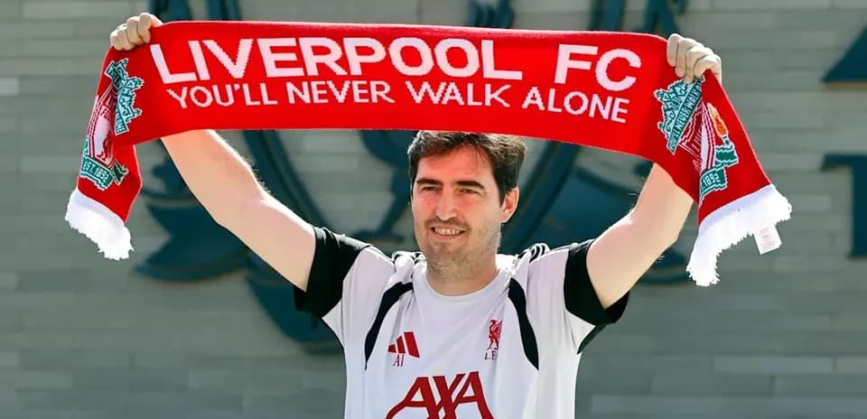 Man holding Liverpool FC scarf at club announcement