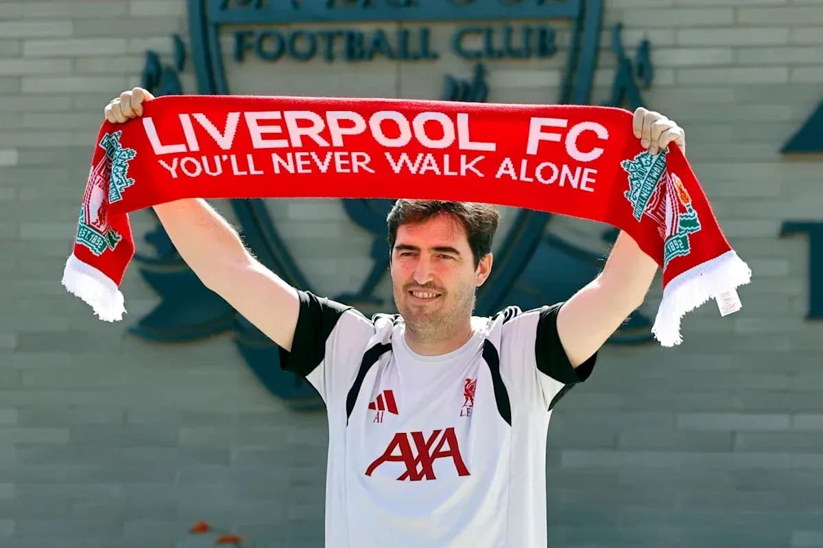 Man holding Liverpool FC scarf at club announcement