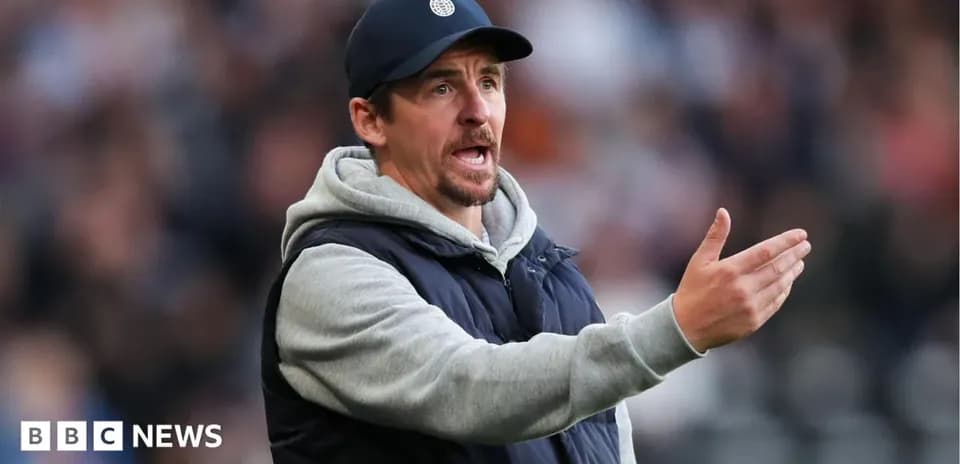 Coach gesturing during a match on the sidelines