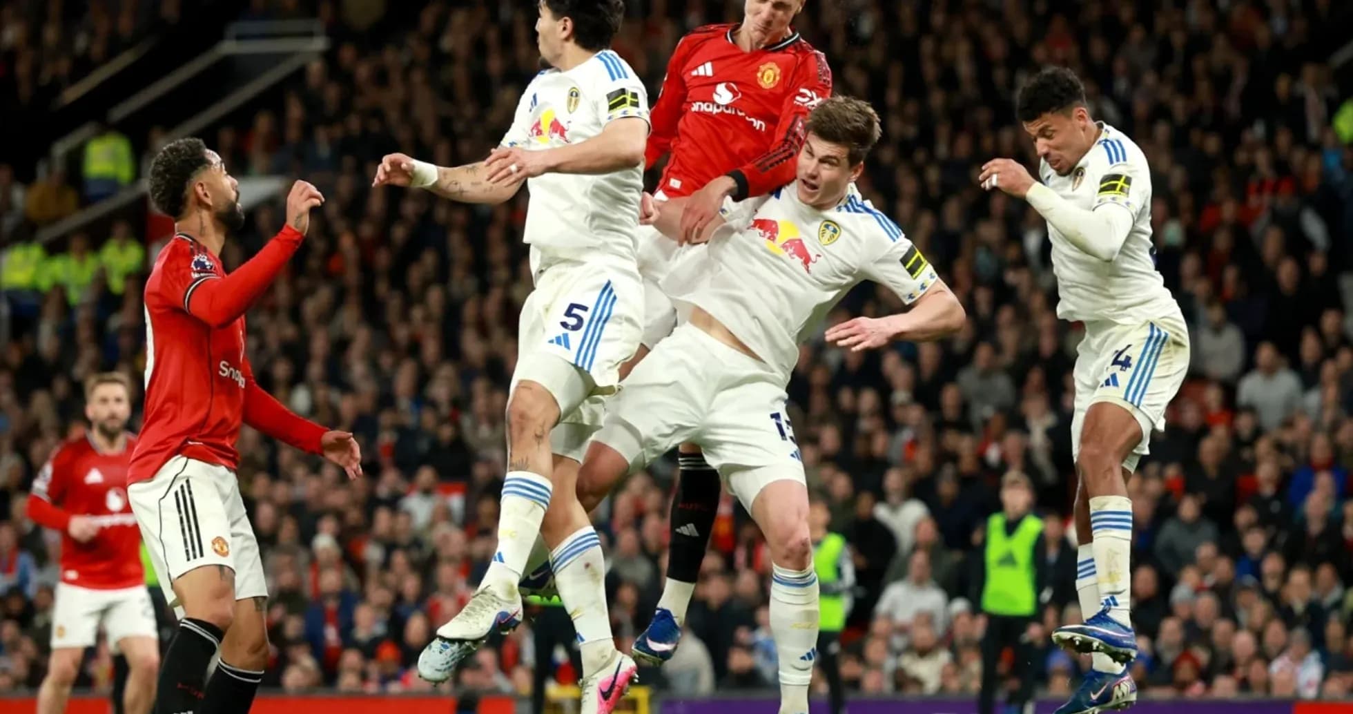 Manchester United and Leeds players contesting a header