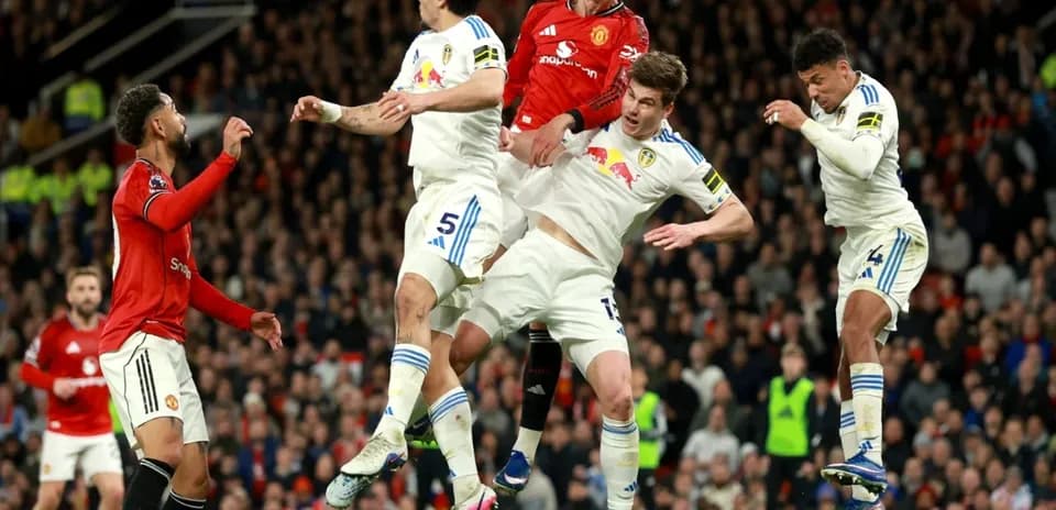 Manchester United and Leeds players contesting a header