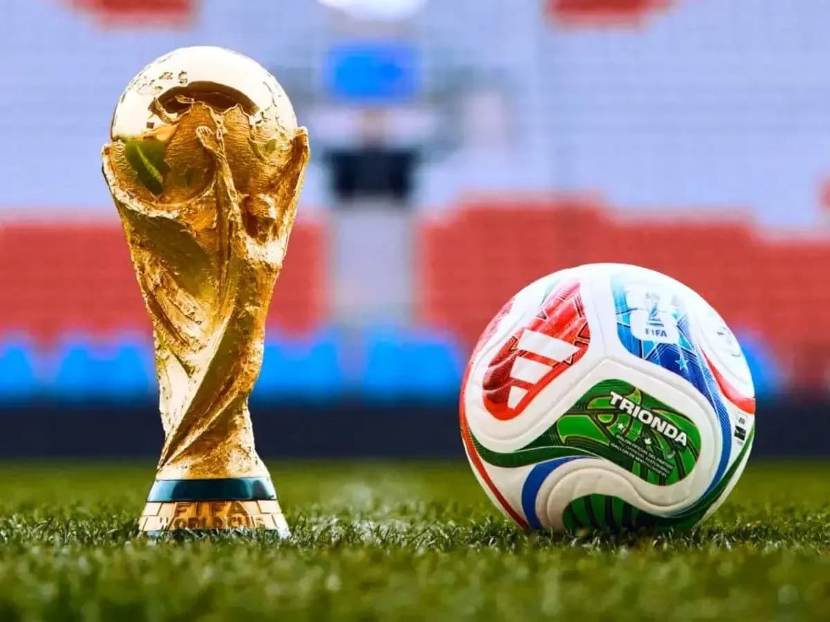 FIFA World Cup trophy next to a soccer ball