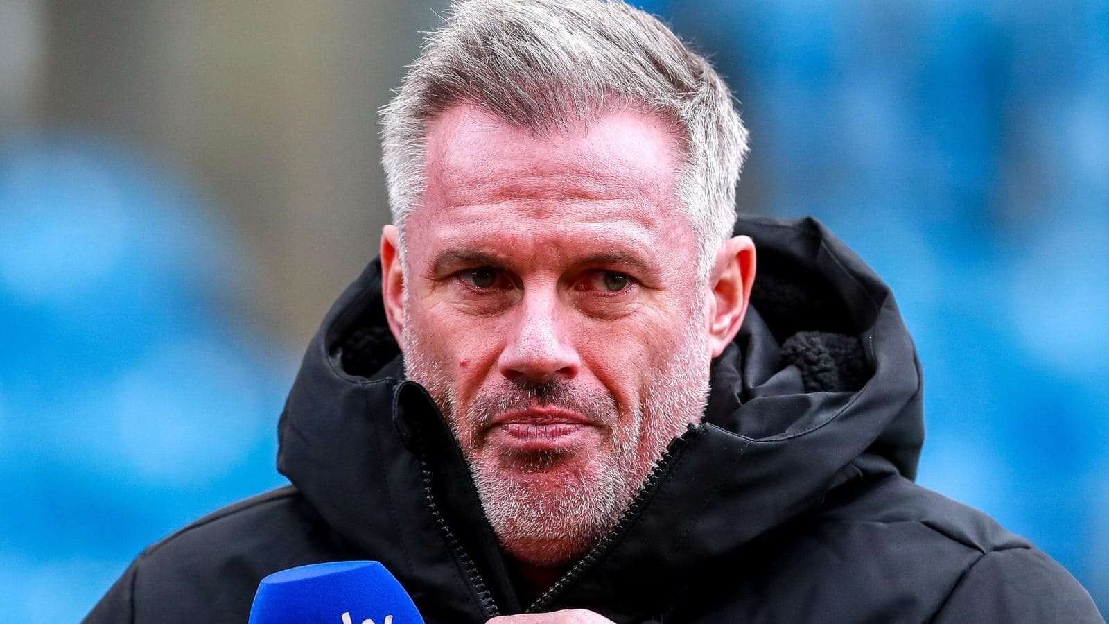 Person speaking into microphone during a broadcast
