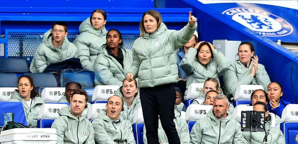Manager directing players from the bench during match