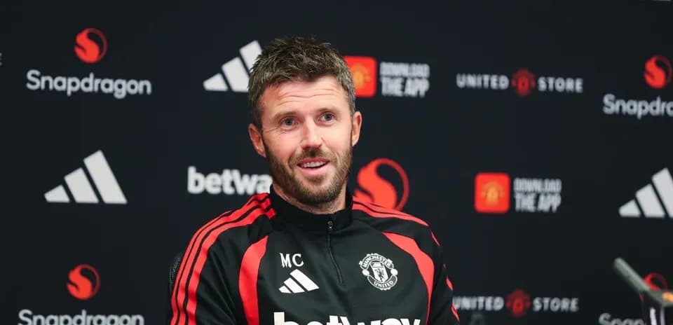 Manager at press conference with Manchester United branding