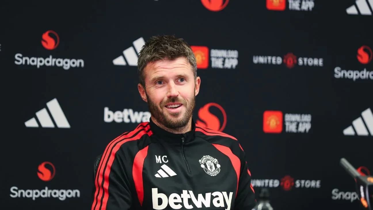 Manager at press conference with Manchester United branding