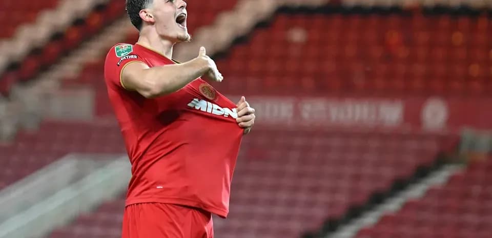Player celebrating by lifting his shirt after scoring
