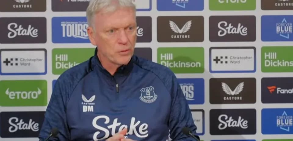 Manager speaking at press conference with Everton branding