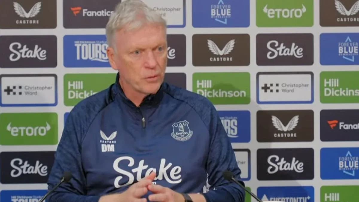 Manager speaking at press conference with Everton branding