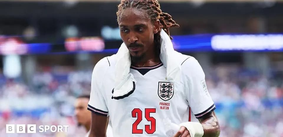 Player wearing England kit walking off the field