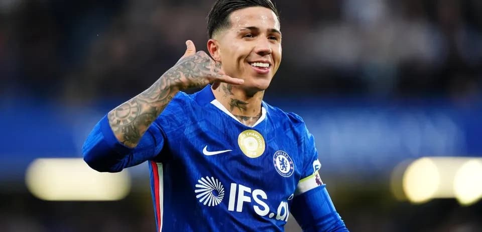 Player celebrating with a phone gesture on pitch