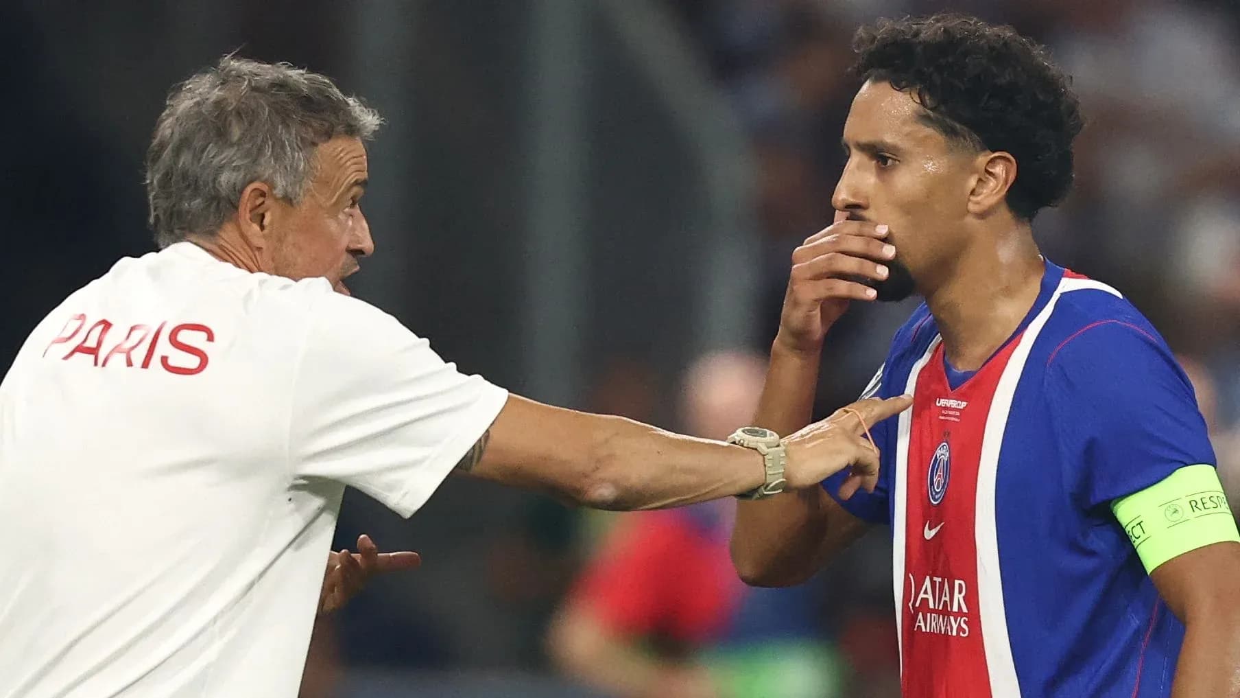 Coach discussing strategy with player during match