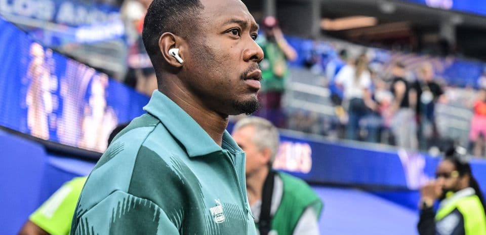 Player walking in team tracksuit before match