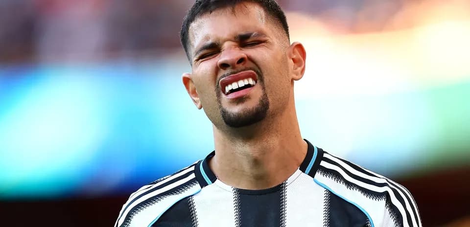 Player reacting during a match in Newcastle kit