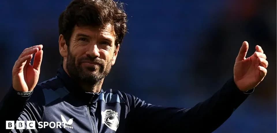Coach gesturing during training session on pitch