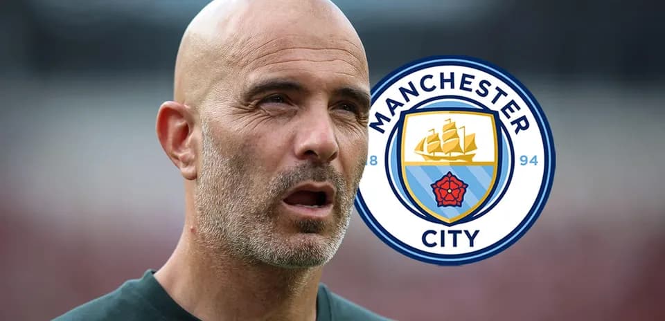 Coach in front of Manchester City logo