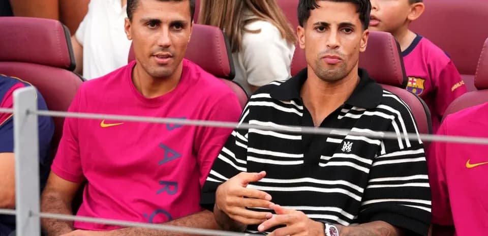 Two men seated in stadium during event
